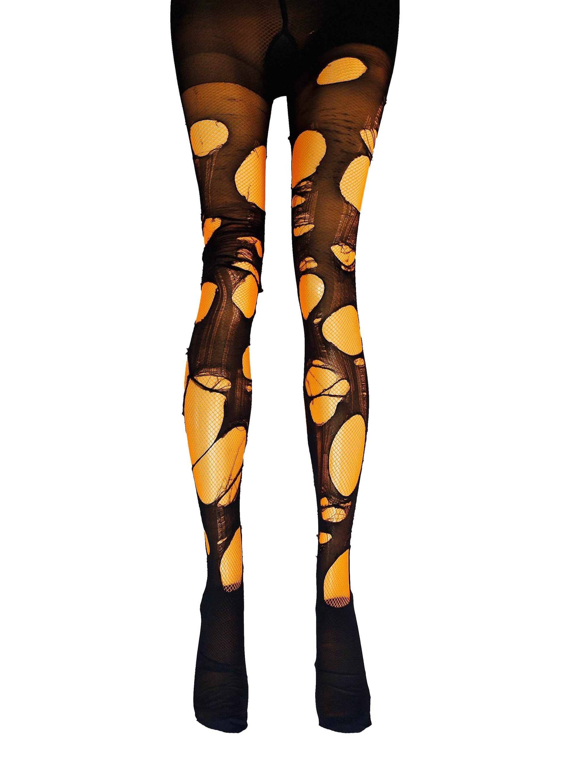 May include: Black fishnet tights with large, irregular holes revealing an orange underlay. The tights extend from the waist to the ankles, with the feet covered in solid black fabric. The overall effect is a distressed, edgy look.